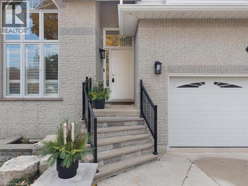 Entrance to property featuring stucco siding and driveway - 90 Westlawn Drive, Hamilton, ON - Outdoor With Exterior