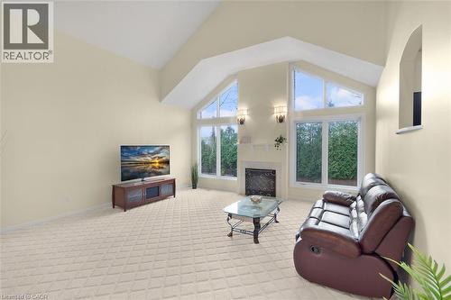 Living area featuring light carpet, lofted ceiling, and a fireplace - 90 Westlawn Drive, Hamilton, ON - Indoor