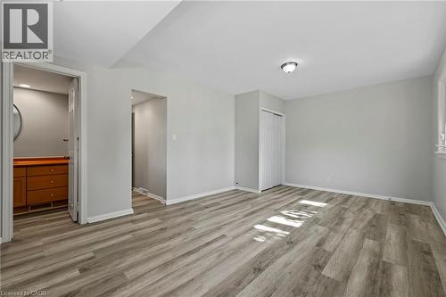 Unfurnished bedroom with light wood-style flooring, a closet, and connected bathroom - 40 Bertram Drive, Dundas, ON - Indoor Photo Showing Other Room