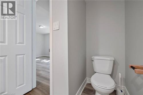 Half bath featuring toilet and wood finished floors - 40 Bertram Drive, Dundas, ON - Indoor Photo Showing Bathroom