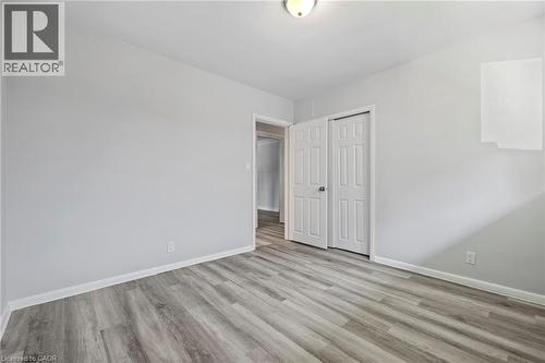 Unfurnished bedroom with light wood-style flooring and a closet - 40 Bertram Drive, Dundas, ON - Indoor Photo Showing Other Room