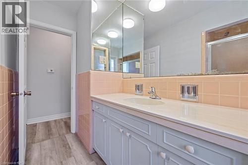 Full bath featuring vanity, tile walls, a wainscoted wall, and light wood-style floors - 40 Bertram Drive, Dundas, ON - Indoor Photo Showing Bathroom