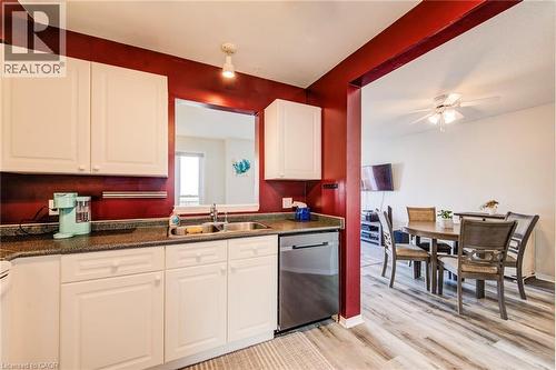 Kitchen is handy to dining area. - 90 Mooregate Crescent Unit# 27, Kitchener, ON 
