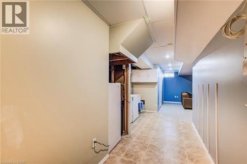 Hallway in basement to Rec Room. Storage under stairs. - 90 Mooregate Crescent Unit# 27, Kitchener, ON 