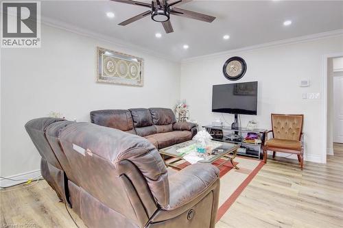 Living area featuring crown molding, a ceiling fan, light wood-type flooring, and recessed lighting - 823 Queensdale Avenue E, Hamilton, ON - Indoor Photo Showing Living Room