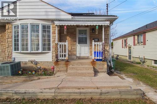 View of front of property featuring stone siding and a porch - 823 Queensdale Avenue E, Hamilton, ON - Outdoor