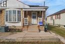 View of front of property featuring stone siding and a porch - 823 Queensdale Avenue E, Hamilton, ON  - Outdoor 