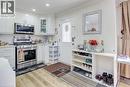 Kitchen featuring white cabinetry, stainless steel appliances, a tile backsplash, and recessed lighting - 823 Queensdale Avenue E, Hamilton, ON  - Indoor Photo Showing Kitchen 