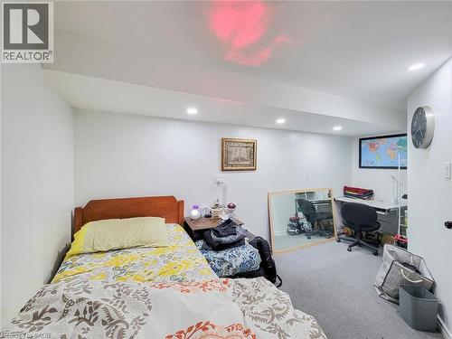 Recessed ceiling lighting illuminates the room with gray carpeting and white walls - 823 Queensdale Avenue E, Hamilton, ON - Indoor Photo Showing Bedroom