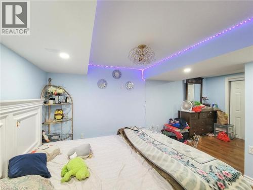Bedroom featuring light blue walls and wood-finish flooring - 823 Queensdale Avenue E, Hamilton, ON - Indoor