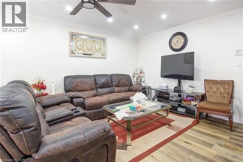 Living room featuring wood finished floors, ornamental molding, recessed lighting, and ceiling fan - 823 Queensdale Avenue E, Hamilton, ON - Indoor Photo Showing Living Room