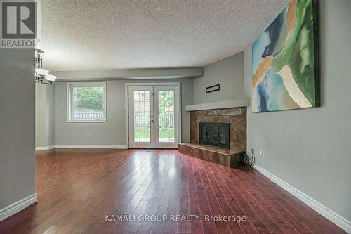 Walkout to Patio & Large Yard - Main - 77 Ecclestone Drive, Brampton, ON - Indoor Photo Showing Living Room With Fireplace
