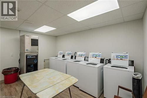 Community laundry with a drop ceiling and washing machine and dryer - 30 John Street, Port Dover, ON 