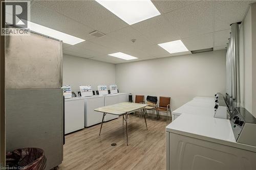 Community laundry with a drop ceiling and washer and dryer - 30 John Street, Port Dover, ON 