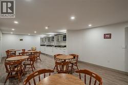 Dining room with recessed lighting and light wood-style floors - 