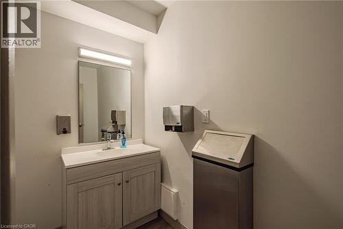 Bathroom featuring vanity and dark wood-style flooring - 30 John Street, Port Dover, ON 