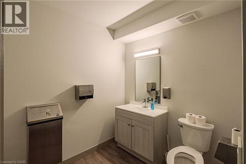 Half bathroom featuring vanity and dark wood-type flooring - 30 John Street, Port Dover, ON 