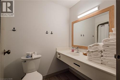 Bathroom with vanity, a shower with curtain, and dark wood-style flooring - 30 John Street, Port Dover, ON 