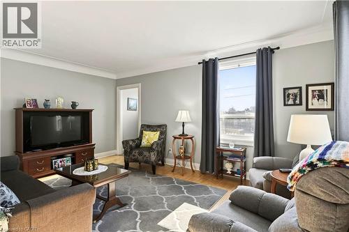 Living area with wood finished floors and crown molding - 944 Garth Street, Hamilton, ON - Indoor Photo Showing Living Room