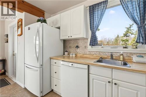 Kitchen with white cabinets, white appliances, light countertops, and backsplash - 944 Garth Street, Hamilton, ON - Indoor Photo Showing Kitchen