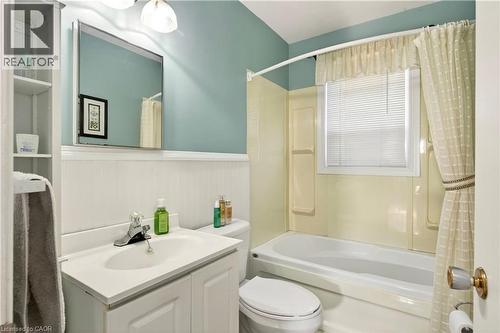 Full bathroom featuring vanity, wainscoting, and shower / bathtub combination with curtain - 944 Garth Street, Hamilton, ON - Indoor Photo Showing Bathroom