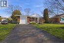 View of front of house with asphalt driveway, a garage, covered porch, a chimney, and brick siding - 71 Pinecrest Drive, Kitchener, ON  - Outdoor 