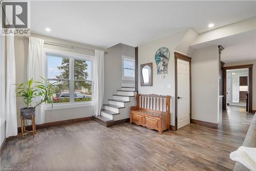 Foyer entrance with dark wood-type flooring and recessed lighting - 23247 Beattie Line, Elgin, ON - Indoor