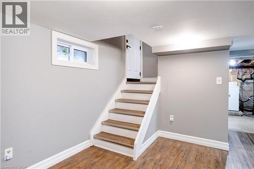 Stairs with wood finished floors and washer / clothes dryer - 23247 Beattie Line, Elgin, ON - Indoor Photo Showing Other Room