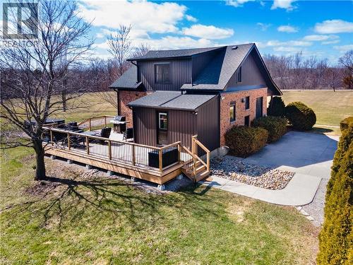 Back of house with a yard, a deck, and a shingled roof - 23247 Beattie Line, Elgin, ON - Outdoor With Deck Patio Veranda