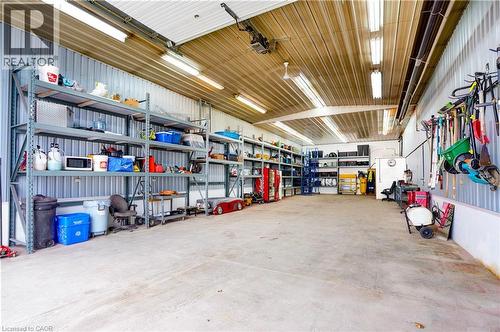Garage with metal wall and a garage door opener - 23247 Beattie Line, Elgin, ON - Indoor Photo Showing Garage