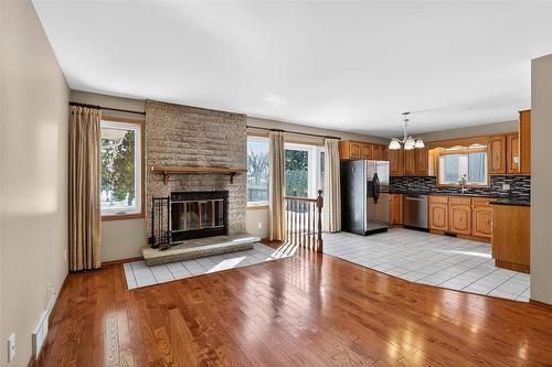 Cozy family room with wood burning fireplace - 37 Optimist Way, Winnipeg, MB - Indoor Photo Showing Living Room With Fireplace