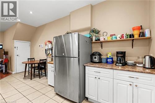 Kitchen with white cabinetry, arched walkways, stainless steel appliances, light tile patterned floors, and recessed lighting - 78 Clyde Street, Hamilton, ON - Indoor Photo Showing Kitchen With Double Sink