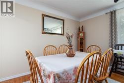 Dining space featuring light wood-style flooring and a textured ceiling - 