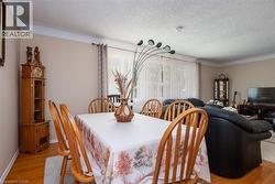 Dining room featuring light wood-style floors and a textured ceiling - 