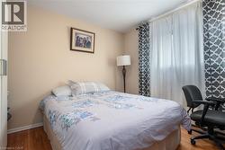 Bedroom with wood finished floors and baseboards - 