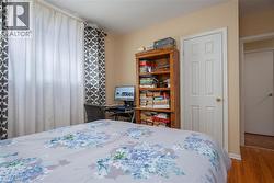 Bedroom with wood finished floors and baseboards - 