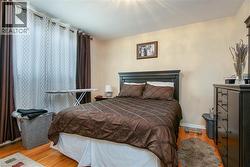 Bedroom with light wood finished floors and baseboards - 