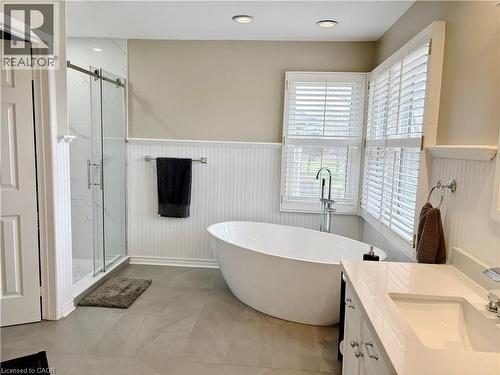 Full bath featuring a wainscoted wall, vanity, a marble finish shower, a soaking tub, and recessed lighting - 2056 Hadfield Court, Burlington, ON - Indoor Photo Showing Bathroom