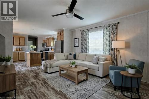 Living area featuring ornamental molding, ceiling fan, and dark wood-style flooring - 77 Park Lane, Flamborough, ON - Indoor Photo Showing Living Room