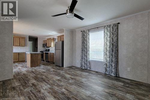 Kitchen with stainless steel appliances, dark wood finished floors, a kitchen island, a ceiling fan, and ornamental molding - 77 Park Lane, Flamborough, ON - Indoor Photo Showing Kitchen