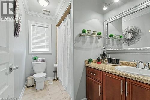 Full bathroom featuring ornamental molding, a shower with curtain, vanity, and light tile patterned floors - 284 Normanhurst Avenue, Hamilton, ON - Indoor Photo Showing Bathroom