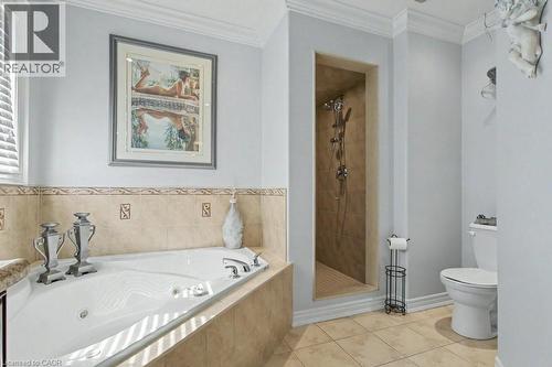 Bathroom featuring a shower stall, light tile patterned flooring, a whirlpool tub, and ornamental molding - 284 Normanhurst Avenue, Hamilton, ON - Indoor Photo Showing Bathroom