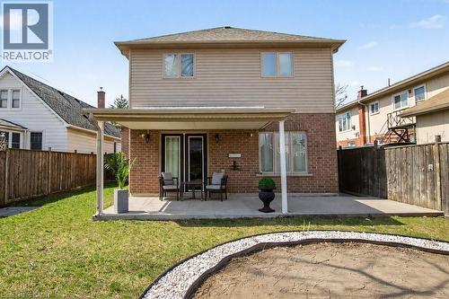 Back of property with a patio, brick siding, and a fenced backyard - 284 Normanhurst Avenue, Hamilton, ON - Outdoor With Exterior