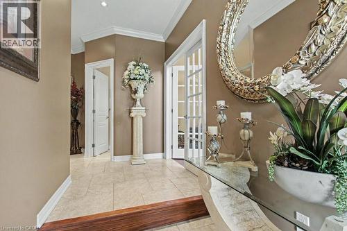 Entryway featuring crown molding, french doors, and light tile patterned floors - 284 Normanhurst Avenue, Hamilton, ON - Indoor Photo Showing Other Room