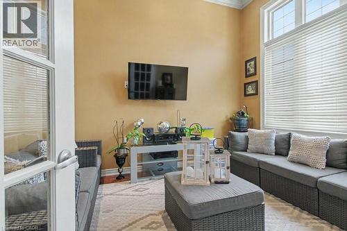 Living area featuring ornamental molding, a high ceiling, and wood finished floors - 284 Normanhurst Avenue, Hamilton, ON - Indoor Photo Showing Living Room