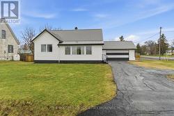 1 1/2 story, full double garage & single at back - 