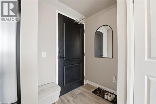 Entrance foyer with light wood-style flooring and baseboards - 120 Springvalley Crescent Unit# 203, Hamilton, ON - Indoor Photo Showing Other Room