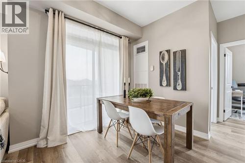 Dining space featuring baseboards and light wood finished floors - 120 Springvalley Crescent Unit# 203, Hamilton, ON - Indoor Photo Showing Dining Room