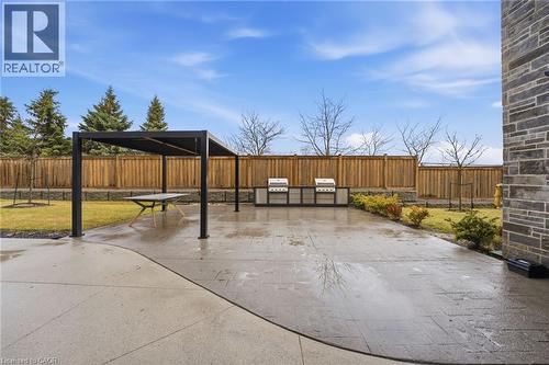 Fenced common backyard with a patio area - 120 Springvalley Crescent Unit# 203, Hamilton, ON - Outdoor
