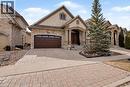 French country style house featuring decorative driveway, stucco siding, an attached garage, and stone siding - 205 Paige Place, Kitchener, ON  - Outdoor With Facade 